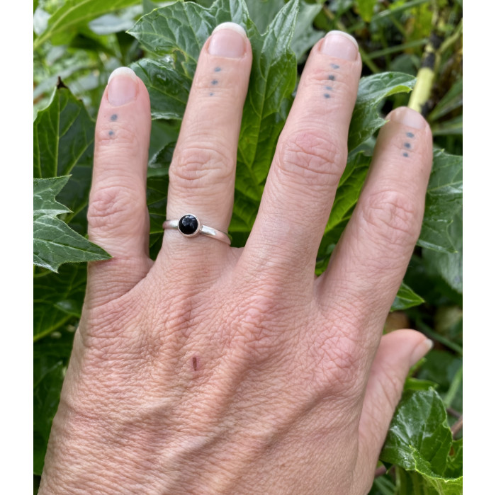 small obsidian and sterling silver ring on hand