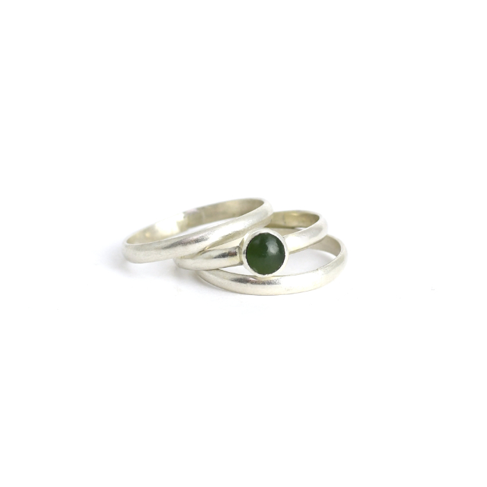 small pounamu ring with stackers on hand