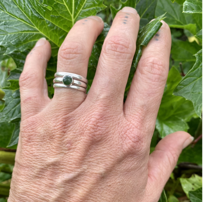 small pounamu ring with stackers on hand