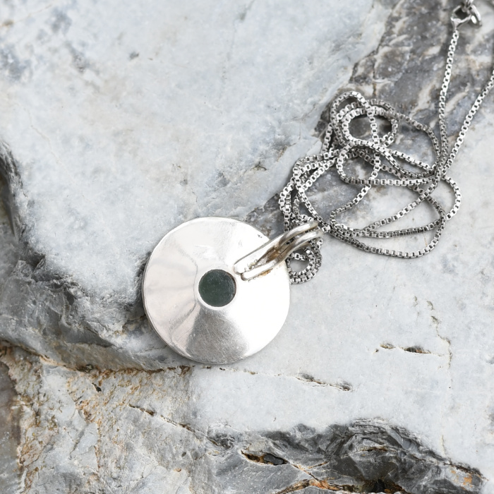 small pounamu dot set in sterling silver, concentric ring pendant